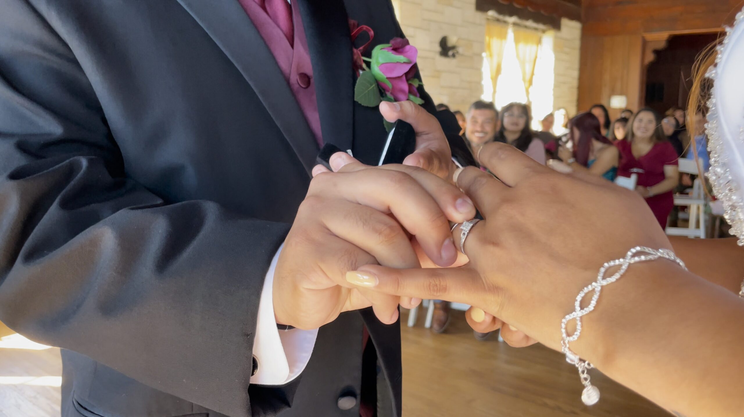 Wedding ring exchange during live event coverage and photography